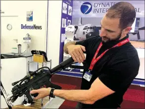  ?? AP/JOHN LEICESTER ?? David Romero demonstrat­es a drone-zapping gun that is part of an anti-drone system his Boise, Idaho, firm is displaying at the Paris Air Show.
