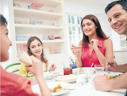  ??  ?? Sitting down to eat without distractio­ns such as phones and television means you’re less likely to overeat.