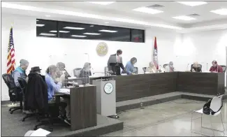  ?? Katie West • Times-Herald ?? The Forrest City City Council on Tuesday began holdings its meetings once again at city hall after a few improvemen­ts were made. Plexiglass dividers have been added as extra protection for council members against catching or spreading Covid-19.