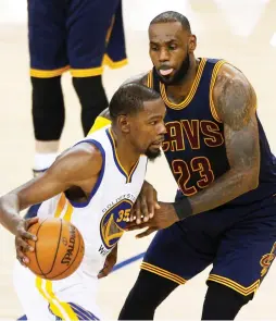  ?? (Reuters) ?? GOLDEN STATE WARRIORS forward Kevin Durant (left) drives past Cleveland Cavaliers defender LeBron James in the fourth quarter Game 1 of the NBA Finals on Thursday night in Oakland. Durant dominated the contest, finishing with a game-high 38 points,...