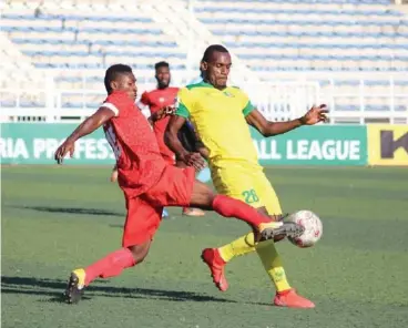  ??  ?? Kano Pillars striker, Nyima Nwagua (R) fights for the ball with a defender of Wikk Turists during their NPFL week 5 match played yesterday at the Sani Abachja stadium in Kano.