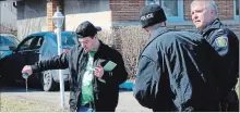  ?? THE ST. CATHARINES STANDARD FILE PHOTO ?? A St. Patrick's Day partygoer dumps out a can of beer on Jacobson Avenue as Niagara Regional Police watch and try to keep parties in the area from getting out of control in March.