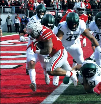 ?? Photo by Mike Frank ?? Ohio State’s Miyan Williams crosses the goal line against Michigan State on Saturday
at Ohio Stadium.