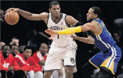  ?? Frank Franklin II / Associated Press ?? The Warriors’ Andre Iguodala tries to contain Brooklyn’s Joe Johnson, who led the Nets with 27 points.