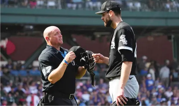  ?? MATT YORK/AP ?? Sox starter Lucas Giolito — feeling leaner and more athletic after dropping about 25 pounds — confers with umpire Scott Barry during his outing Friday afternoon against the Cubs.