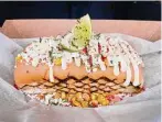  ?? ?? The Dogfather: The Elote is built around a beef frank and Mexican street corn.