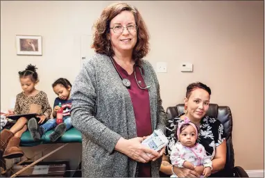  ?? ?? Midwife Carolyn Greenfield, front, with client Cameron English of Middletown at her Rocky Hill office. Greenfield was the midwife for the birth of English’s daughter Iyami. Her siblings are Msanii, 5, and Amini, 3.