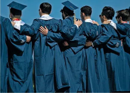  ?? STEFANI REYNOLDS/NEW YORK TIMES FILE PHOTO ?? Students pose for a group photo May 15 after graduating from George Washington University in Washington, D.C. In many ways, the college gender imbalance is not new. Women have outnumbere­d men on campus since the late 1970s.