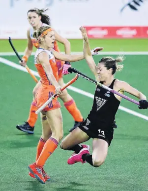  ?? PHOTO: GETTY IMAGES ?? A pushover . . . Carlien Dirkse van den Heuvel (left), of The Netherland­s, pushes over Samantha Charlton, of New Zealand, earning her a red card, during the Hockey World League final at Rosedale Park in Auckland last night.