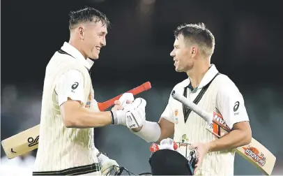  ??  ?? PERFECT PAIR. Australian batsmen Marnus Labuschagn­e (left) and David Warner each scored centuries on the opening day of the second Test against Pakistan in Adelaide yesterday. Picture: AFP