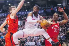  ?? MARK BLINCH/THE CANADIAN PRESS ?? Miami Heat guard Dwyane Wade was part of a strong Miami heat second unit that gave Jakob Poeltl, left, DeMar DeRozan and the rest of the Toronto Raptors fits Tuesday in Toronto.