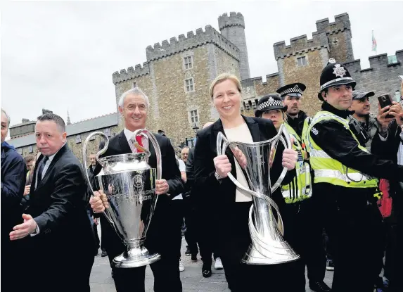  ?? Wales News Service ?? > The men’s and women’s Uefa Champions League trophies arrive in Cardiff and are carried by Welsh and Liverpool football legend Ian Rush and Welsh football coach Jayne Ludlow from Cardiff Castle to the Principali­ty Stadium, where the finals will be...