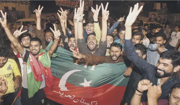  ?? PICTURE: ARIF ALI/AFP/GETTY ?? 0 Supporters of Imran Khan’s Tehreek-e-insaf party celebrate in Lahore as early projection­s showed the party well ahead in the polls