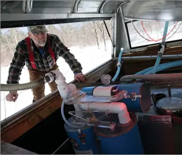  ?? MATT STONE PHOTOS — BOSTON HERALD ?? Joe Raskett checks out his sap pump.