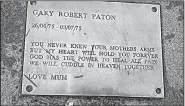  ?? Photo courtesy of Lydia Reid ?? “There was never any child’s remains in that coffin,” Lydia Reid said after the coffin was dug up from her son Gary Paton’s grave at Saughton Cemetery in Edinburgh, Scotland. This plate is on a bench at the grave.