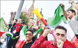  ??  ?? Iran’s national football team fans cheer outside the Kremlin in Moscow on June 13, ahead of the Russian 2018
World Cup football tournament. (AFP)