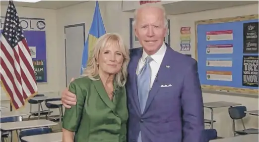  ?? DNCC VIA GETTY IMAGES ?? Democratic presidenti­al nominee Joe Biden with wife Dr. Jill Biden in a classroom after she addressed the virtual convention.