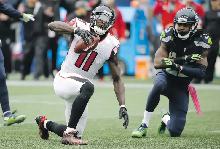  ?? — AP FILES ?? The Falcons’ Julio Jones reacts after the Seahawks’ Richard Sherman, right, broke up a pass intended for him on Oct. 16 in Seattle. Jones and the Falcons get another shot at Seattle in Saturday’s game.