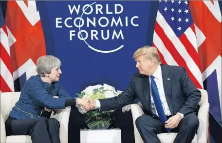  ?? Evan Vucci Associated Press ?? PRESIDENT Trump and British Prime Minister Theresa May meet in Davos. “We’re on the same wavelength,” Trump said.