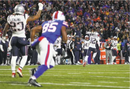  ?? Jeffrey T. Barnes / Associated Press ?? New England safety Devin McCourty seals the win by returning his intercepti­on of a Derek Anderson pass 85 yards for a score.