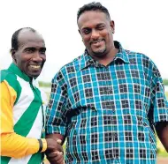  ??  ?? Trainer Sean Williams (right) is congratula­ted by jockey Shane Ellis after he saddled his first winner, SIR LEYLAND HALL, on Wednesday.