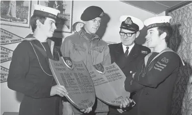  ??  ?? (Left to right) Petty Officer Brian Rooney, Corporal John Culley, Commander C W Poth and Petty Officer Michael Wigmore in 1970. Ref:132383-5