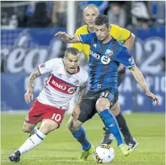  ?? PAUL CHIASSON/THE CANADIAN PRESS ?? Toronto FC forward Sebastian Giovinco, left, and Montreal Impact’s Blerim Dzemaili battle for the ball during second half of the first leg of the Canadian Championsh­ip soccer final action, in Montreal last Wednesday.