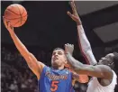  ?? KELLY LAMBERT/USA TODAY SPORTS ?? Former Gators guard Scottie Wilbekin shoots the ball around Alabama guard Rodney Cooper at Coleman Coliseum in 2014.