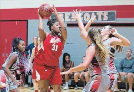  ?? JULIE JOCSAK THE ST. CATHARINES STANDARD ?? Denis Morris’s Rayshell Nyamekye attempts a shot against Jean Vanier at the Standard Girls High School Basketball Tournament in St. Catharines.