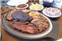  ??  ?? A selection of barbecue (beef brisket, pork ribs, pulled chicken, pulled pork and hot links) at Hek Yeah BBQ.