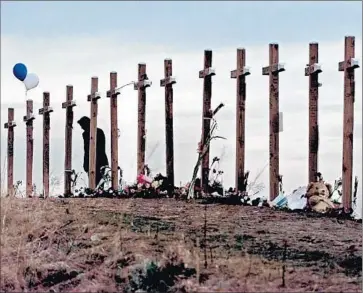  ?? Eric Gay
Associated Press ?? CROSSES ON A HILL above Columbine High School in Littleton, Colo., honor the victims of the 1999 massacre. A study shows that data support the perception that U.S. mass shootings have become more common.