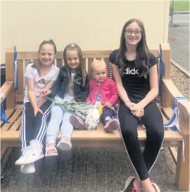  ??  ?? Sian’s daughters, olivia, lucia, Molly and Sophia, on the bench installed by work colleagues