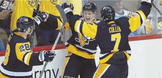  ?? AP PHOTO ?? COOL CELEBRATIO­N: Jake Guentzel (center) gets congratula­tions on his winning goal from Penguins teammates Ian Cole (28) and Matt Cullen in last night’s 5-3 victory against the Predators.