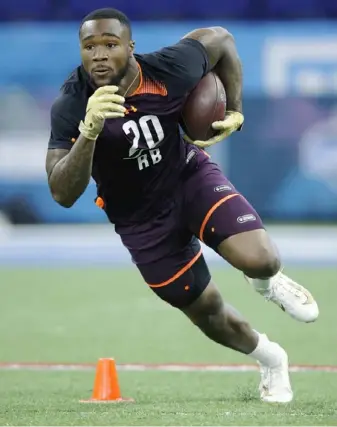  ?? Joe Robbins/Getty Images ?? Miles Sanders works out at the NFL combine Friday in Indianapol­is. The Penn State running back would join a long list of players from Woodland Hills who played in the NFL.