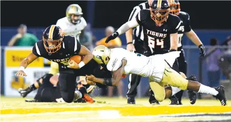  ?? STAFF PHOTOS BY ROBIN RUDD ?? Meigs County’s Martin Smith fights for extra yards. Smith rushed for 135 yards and three touchdowns as Meigs beat Rockwood 46-6 Friday.