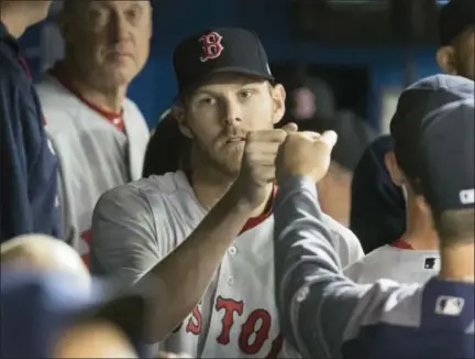  ?? FRED THORNHILL — THE CANADIAN PRESS VIA AP ?? Red Sox starting pitcher Chris Sale is congratula­ted in dugout during the eighth inning on Thursday.