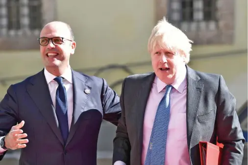  ??  ?? Italian Foreign Minister Angelino Alfano welcomes British Foreign Secretary Boris Johnson as he arrives for a meeting of G-7 foreign ministers in Lucca, Italy. (AFP)