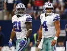  ?? Associated Press ?? Dallas Cowboys running back Ezekiel Elliott (21) and quarterbac­k Dak Prescott (4) walk off the field after an unsuccessf­ul two-point conversion in the second half of an NFL football game Oct. 1 against the Los Angeles Rams in Arlington, Texas. Barring...