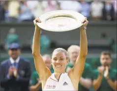  ?? Tim Ireland / Associated Press ?? Germany’s Angelique Kerber lifts the trophy after winning the Wimbledon women’s title over Serena Williams on Saturday.