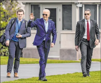  ?? Andrew Harnik
The Associated Press ?? President Joe Biden waves as he walks Friday toward Marine One at the White House for a trip to Andrews Air Force Base and then to Philadelph­ia for a campaign event.