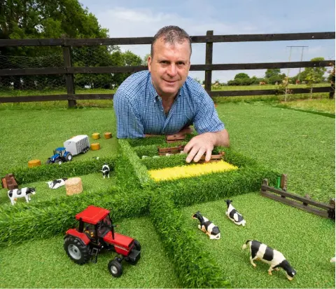  ??  ?? Padraic Cuddy with some of his toy fields, which he was inspired to make by his then three-year-old son, Tommyfor cost reasons, and are being marketed in the States by a Northern Irish company with experience of the American market.“The signs are good at the moment and the containers are ready to roll. We are hopeful about the American venture”, Padraic says.Back at base in Roscommon Padraic employs seven people working from converted farm buildings on a 30-acre holding near his home farm which hebought to facilitate his growing business. A series of different fields have been developed and, of course, each comes with its own title deed.