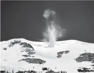  ?? Photos by Helen H. Richardson, The Denver Post ?? An avalanche bomb explodes in a large cornice above Colorado 82 as crews prepare to open the road over Independen­ce Pass in time for Memorial Day.