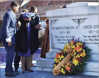  ?? Paras Griffin / Getty Images ?? Christine King Farris, sister of Martin Luther King Jr., is seen with family members laying a wreath on the tomb of King and Coretta Scott King during the 2021 King Holiday Observance Beloved Community Commemorat­ive Service at the King Center on Monday in Atlanta.