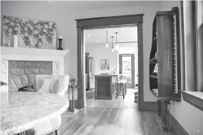  ?? Photo courtesy of Tay Whiteside/Black Dog Salvage ?? ■ A repurposed baby grand piano serves as shelving on the dining room wall at Stone House.