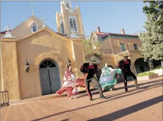  ?? PHOTO COURTESY OF ITSATRIP.ORG ?? Folklorico dancers perform in front of the San Felipe de Neri Church in Old Town, a section of Albuquerqu­e, N.M. The city is celebratin­g the 100th anniversar­y of the statehood of New Mexico with several events.