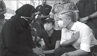  ?? BEIRUT, LEBANON
-REUTERS ?? Canadian Foreign Minister Francois-Philippe Champagne gestures as he meets with a woman affected by the massive blast in Beirut's port area, at World Food Program (WFP) distributi­on site.