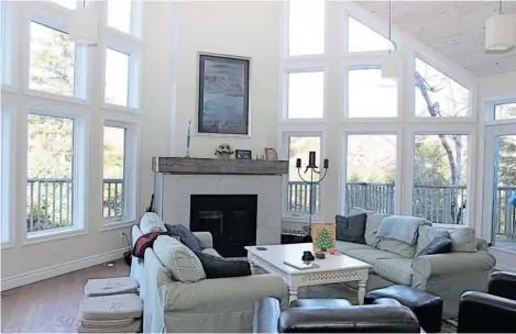  ?? PHOTOS: HELGA LOVERSEED/ THE GAZETTE ?? The open-plan living room in the Ryans’ country home has a sloping cathedral ceiling and floor-to-ceiling windows.