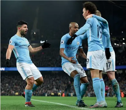  ?? AFP ?? Sergio Aguero (second left) celebrates with teammates after completing his hat trick against Newcastle in Premier League match. —