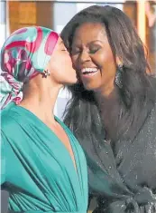  ??  ?? Alicia Keys welcomes Michelle Obama to the stage and tumultuous applause in a celebratio­n of female empowermen­t at the Grammys.