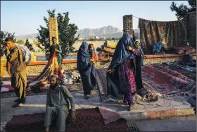  ?? (File Photo/AP/Bernat Armangue) ?? Afghan women walk Wednesday through a secondhand market where many families sold their belongings before leaving the country or due to financial struggle in Kabul, Afghanista­n. Stories circulatin­g online incorrectl­y assert that CNN had reported that the Taliban banned menstrual hygiene products in Afghanista­n, saying it goes against Sharia law. CNN did not publish such an article and no credible reports can be found to support any such action by the Taliban.